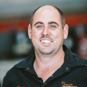 Matt headshot photo at Daniels Automotive workshop working as motor mechanic